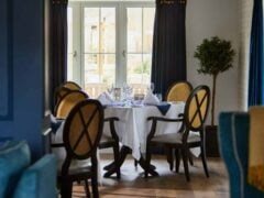 Elegant dining room with round table setting.