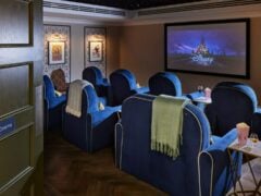 Luxurious home cinema room with Disney movie playing.