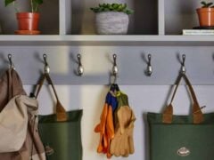 Gardening gloves and bags hanging on hooks.