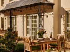 Outdoor patio with tables, chairs, and flowers