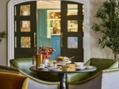 Cosy tearoom with scones and teacups on the table.